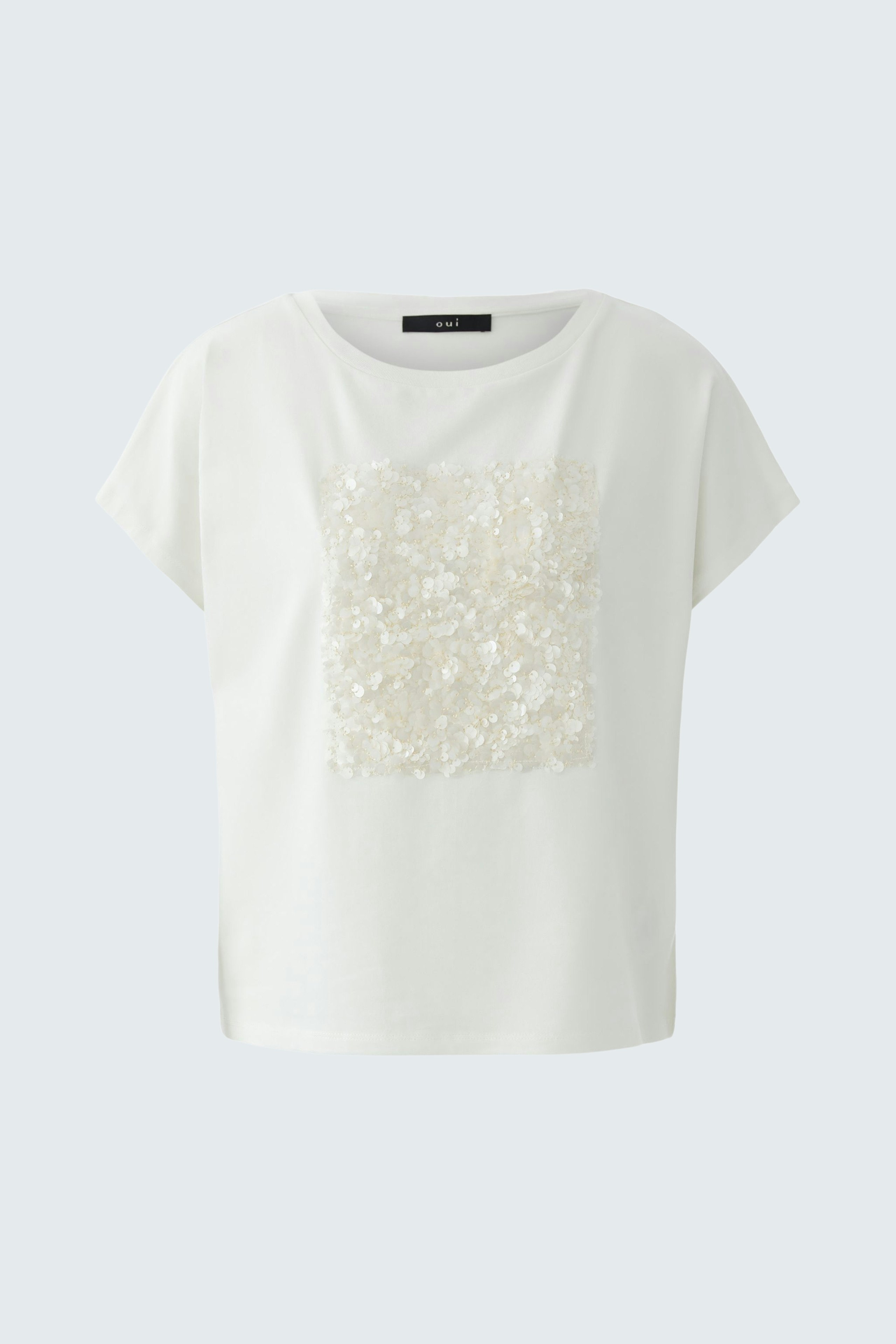 Casual women's T-shirt: A woman in a white tee with a textured square design, perfect for everyday wear.