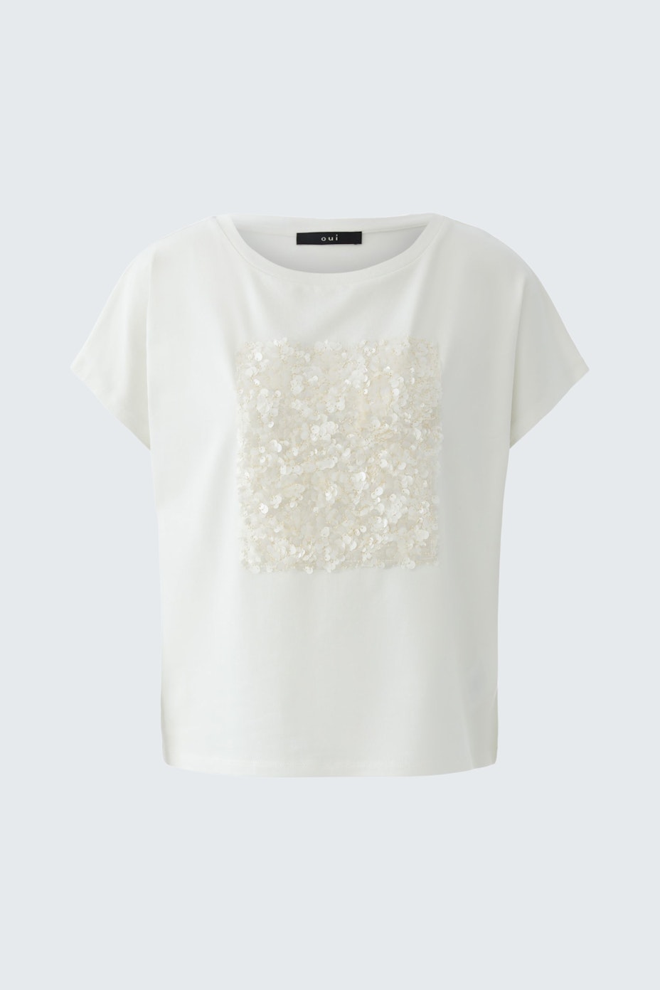 Casual women's T-shirt: A woman in a white tee with a textured square design, perfect for everyday wear.