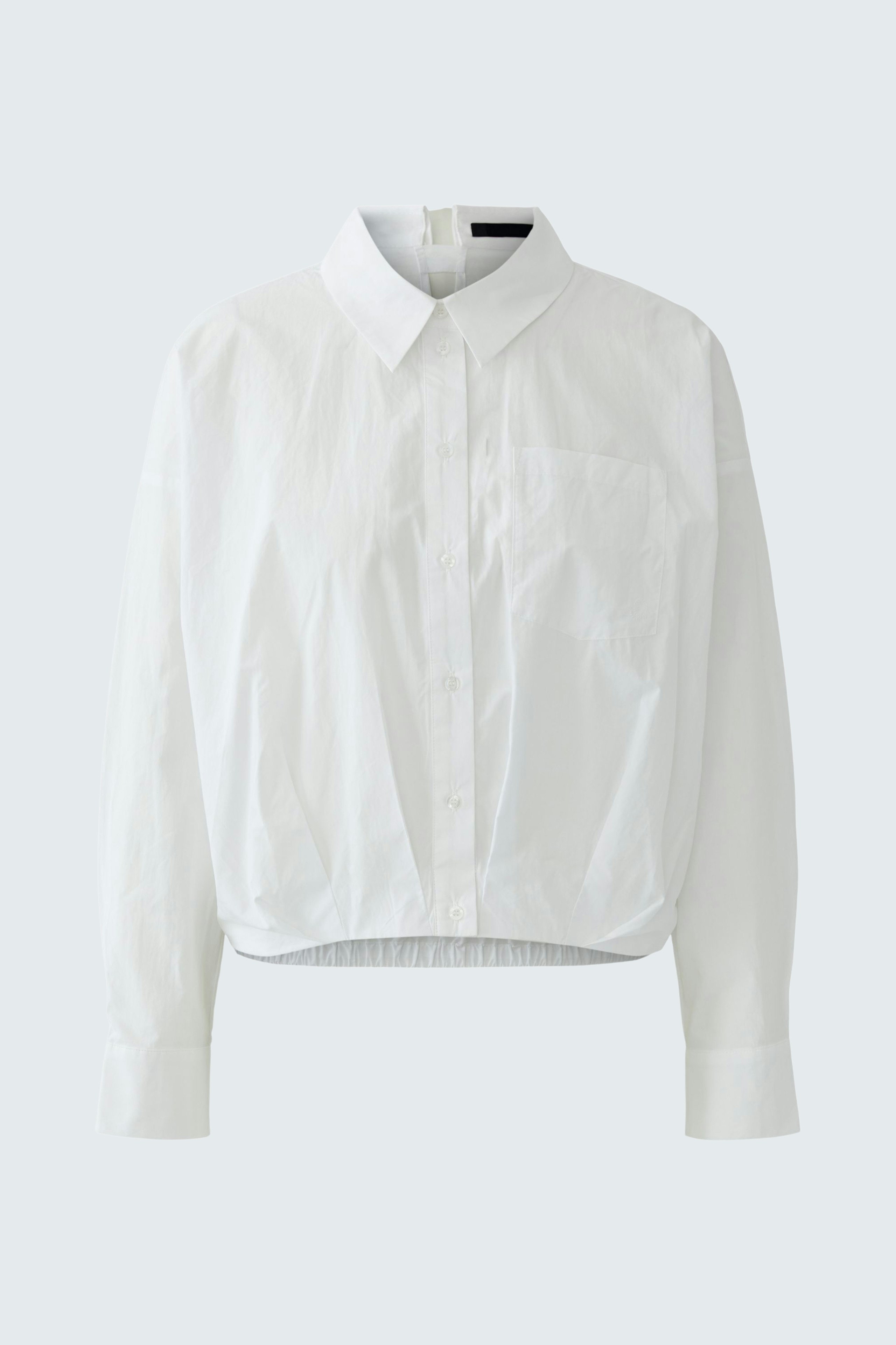 Casual women's blouse: White cropped blouse with a classic collar and button closure.