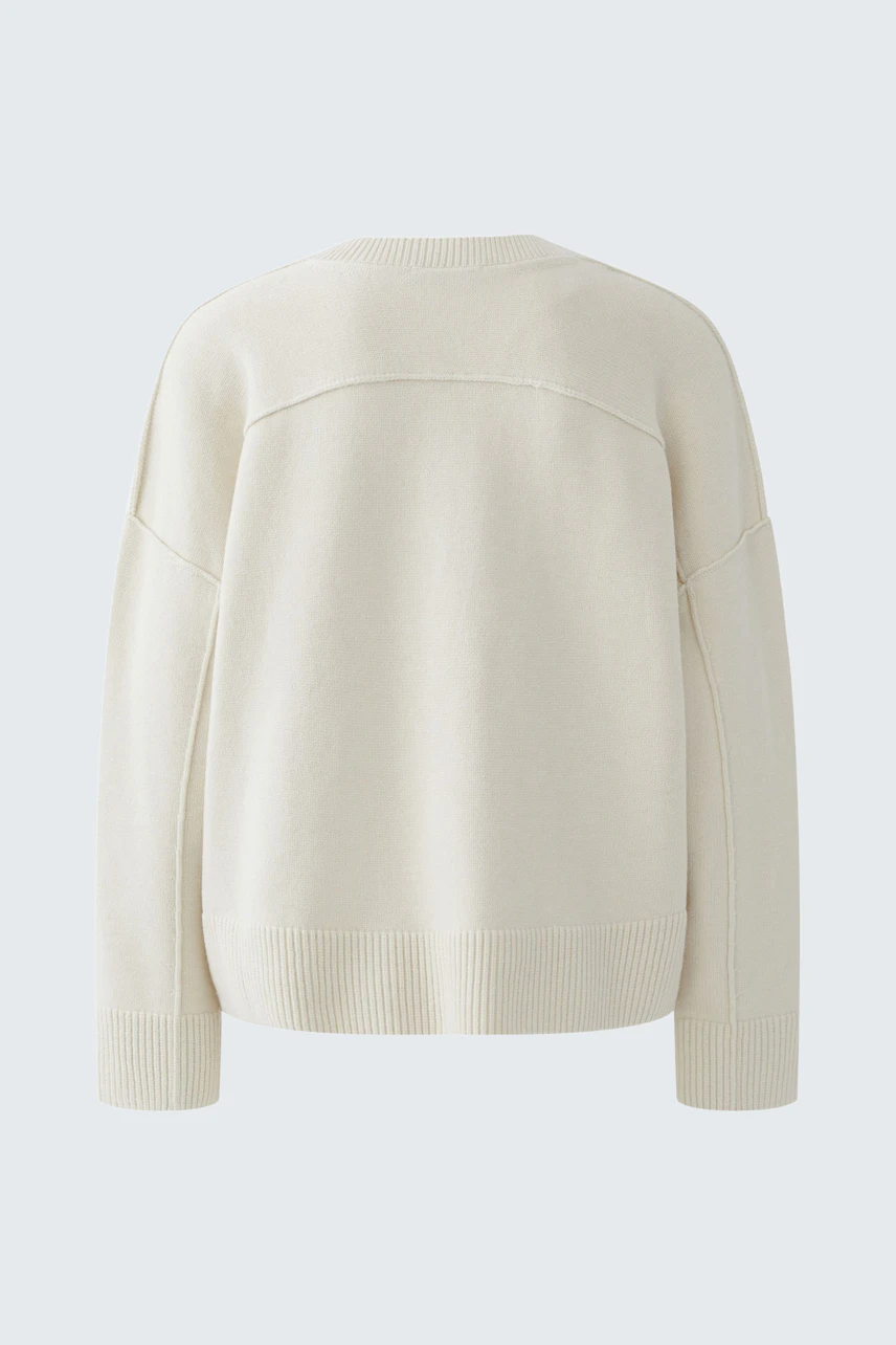 Casual women's pullover: Back view of a soft cream pullover with a relaxed fit and ribbed hem.