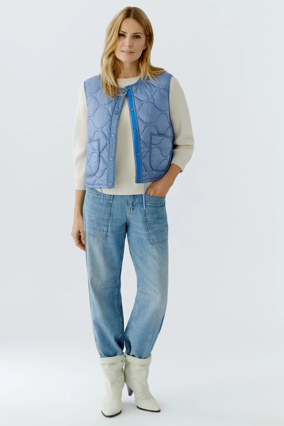 Reversible jacket: A woman in a light blue quilted vest with pockets, perfect for layering.