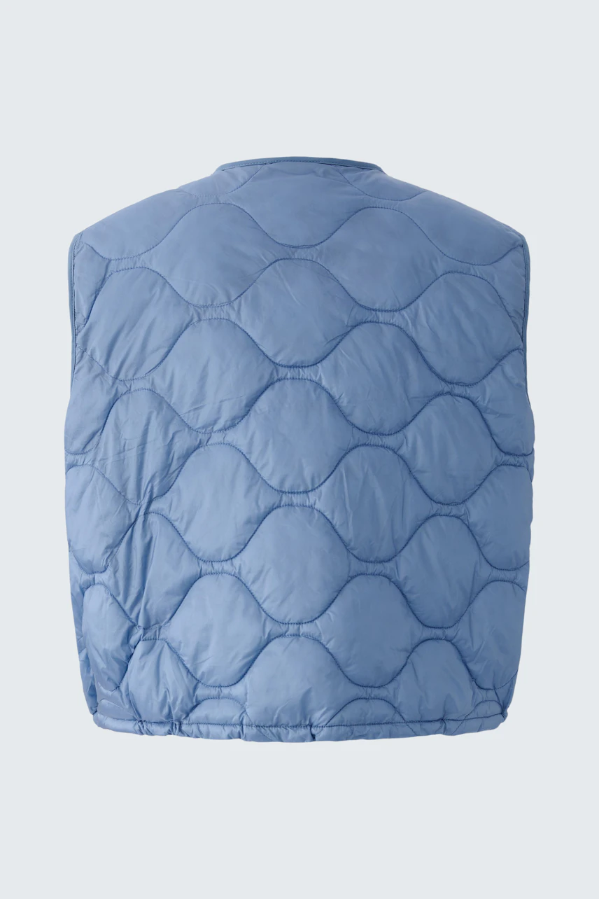 Reversible jacket: A woman in a light blue quilted reversible jacket, perfect for layering.