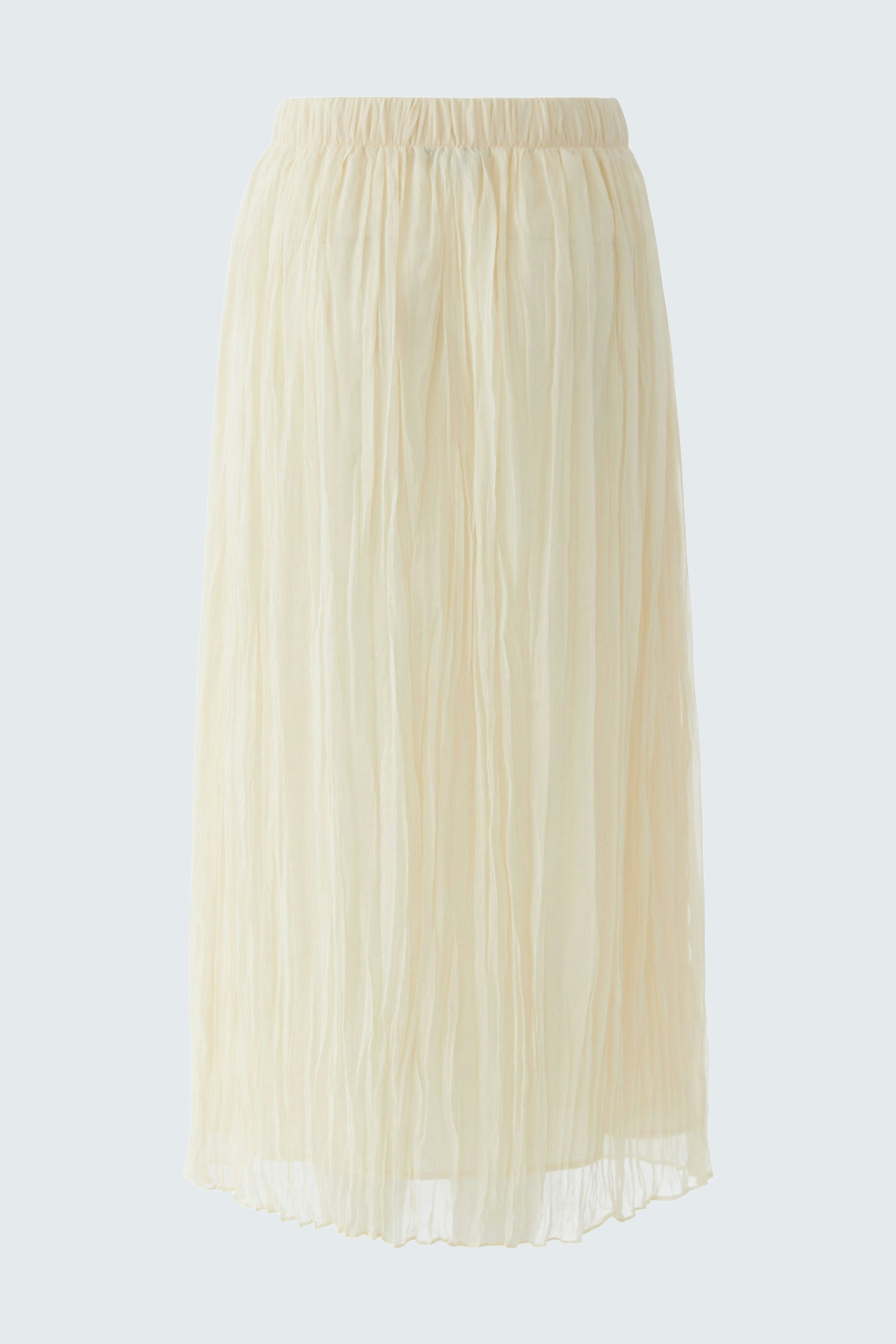 Light pleated skirt: A woman in a flowing, cream-colored pleated skirt, perfect for casual outings.