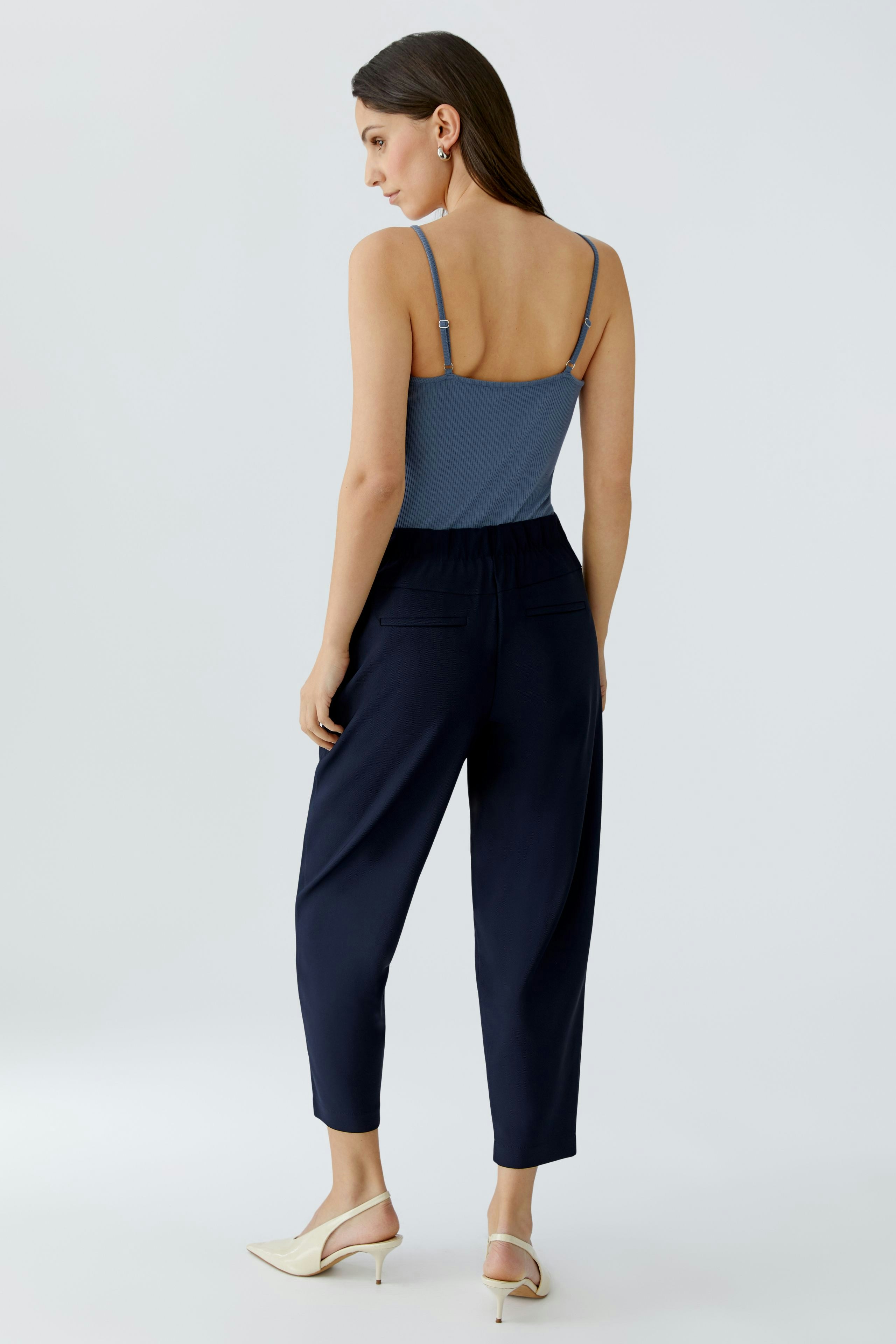 Casual women's trousers: A woman in navy pants with a relaxed fit and elastic waistband, showcasing comfort.