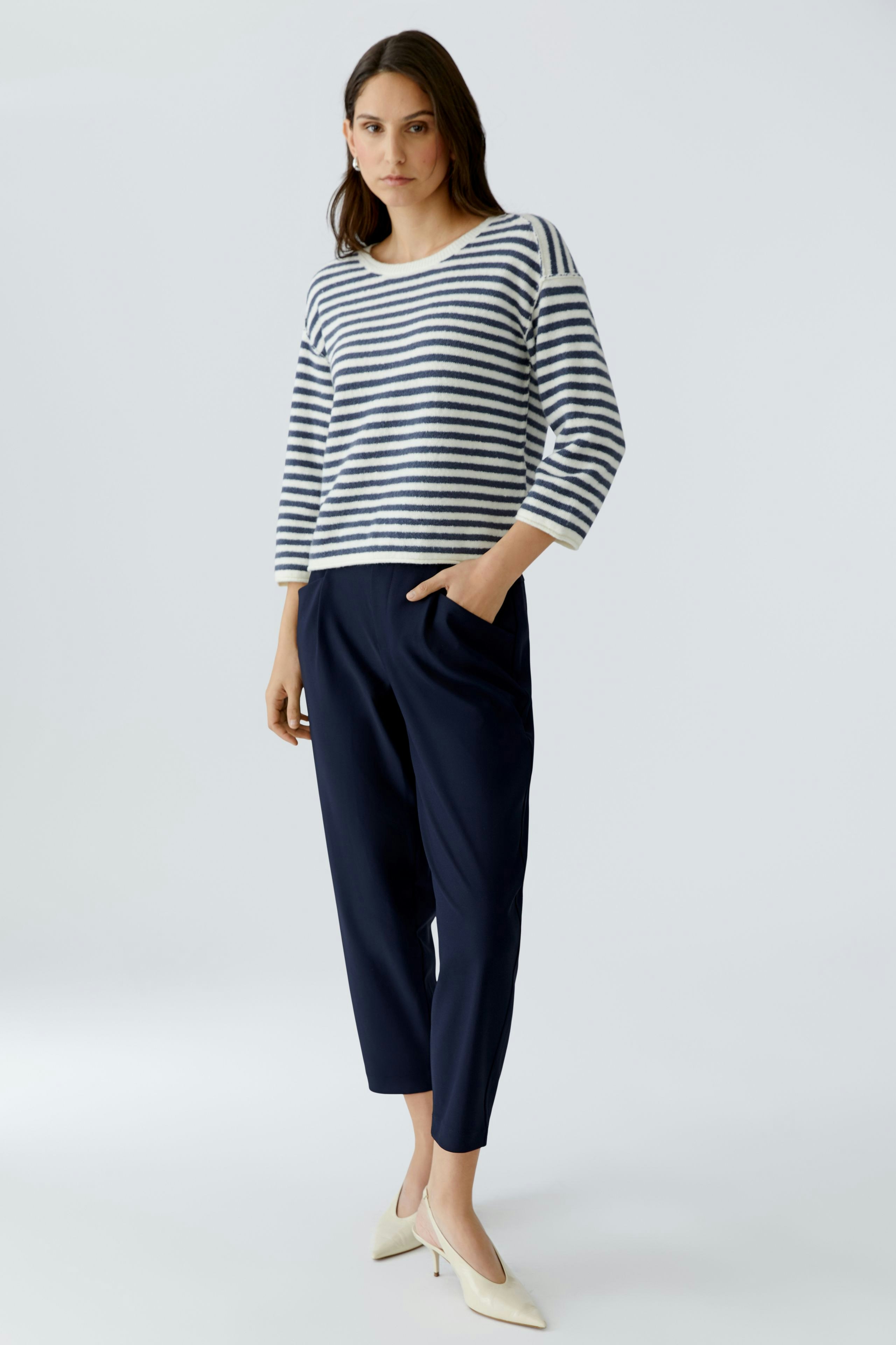 Comfortable women's pants in navy, paired with a striped pullover, perfect for casual wear.