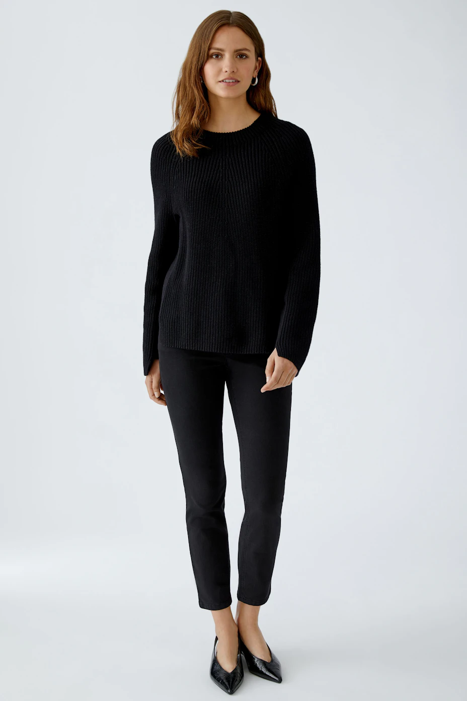 Casual women's pullover: Black ribbed pullover with a relaxed fit and side tie detail.