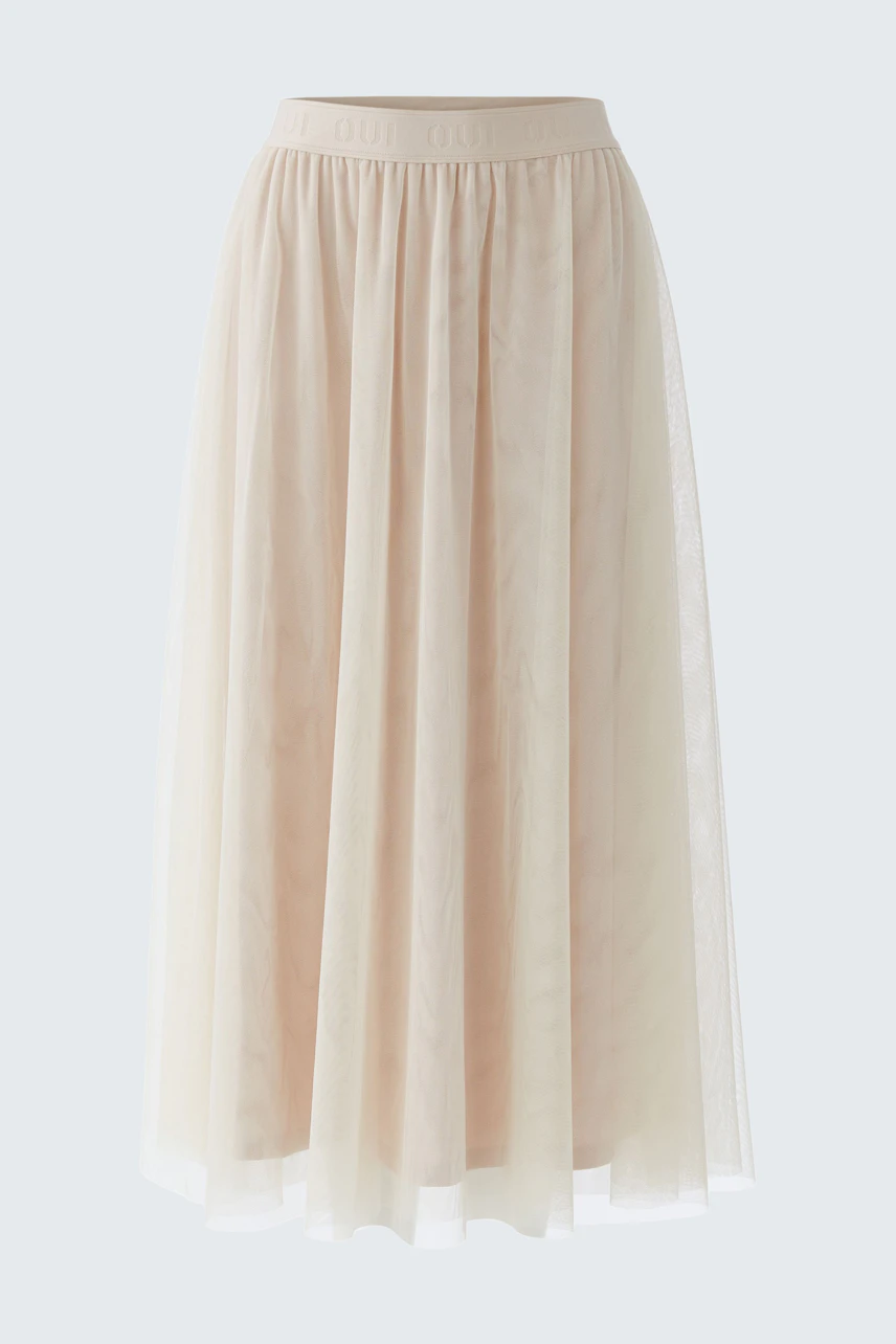 Flowy A-line skirt in soft beige tulle, perfect for a casual and chic look.