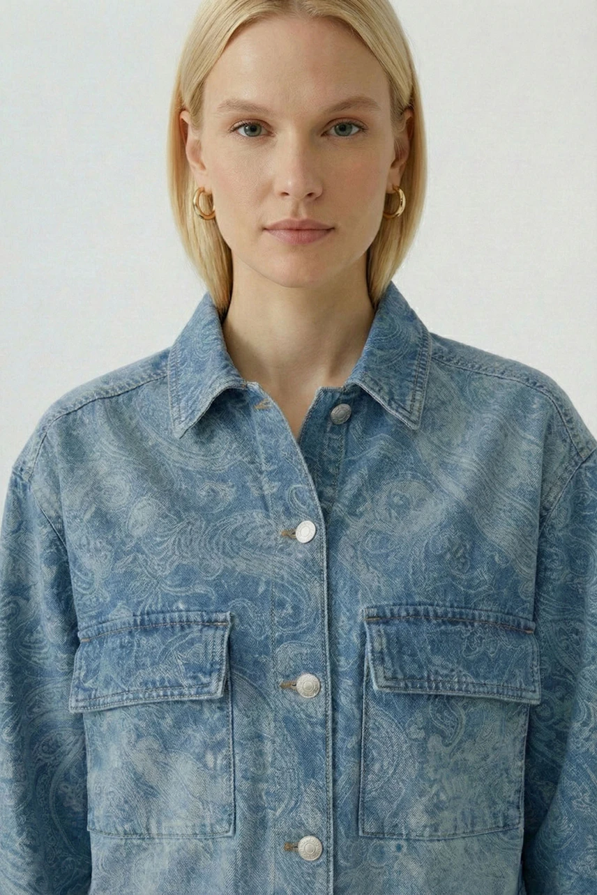 Denim jacket: Woman in a blue patterned jeans jacket with button closure and front pockets.