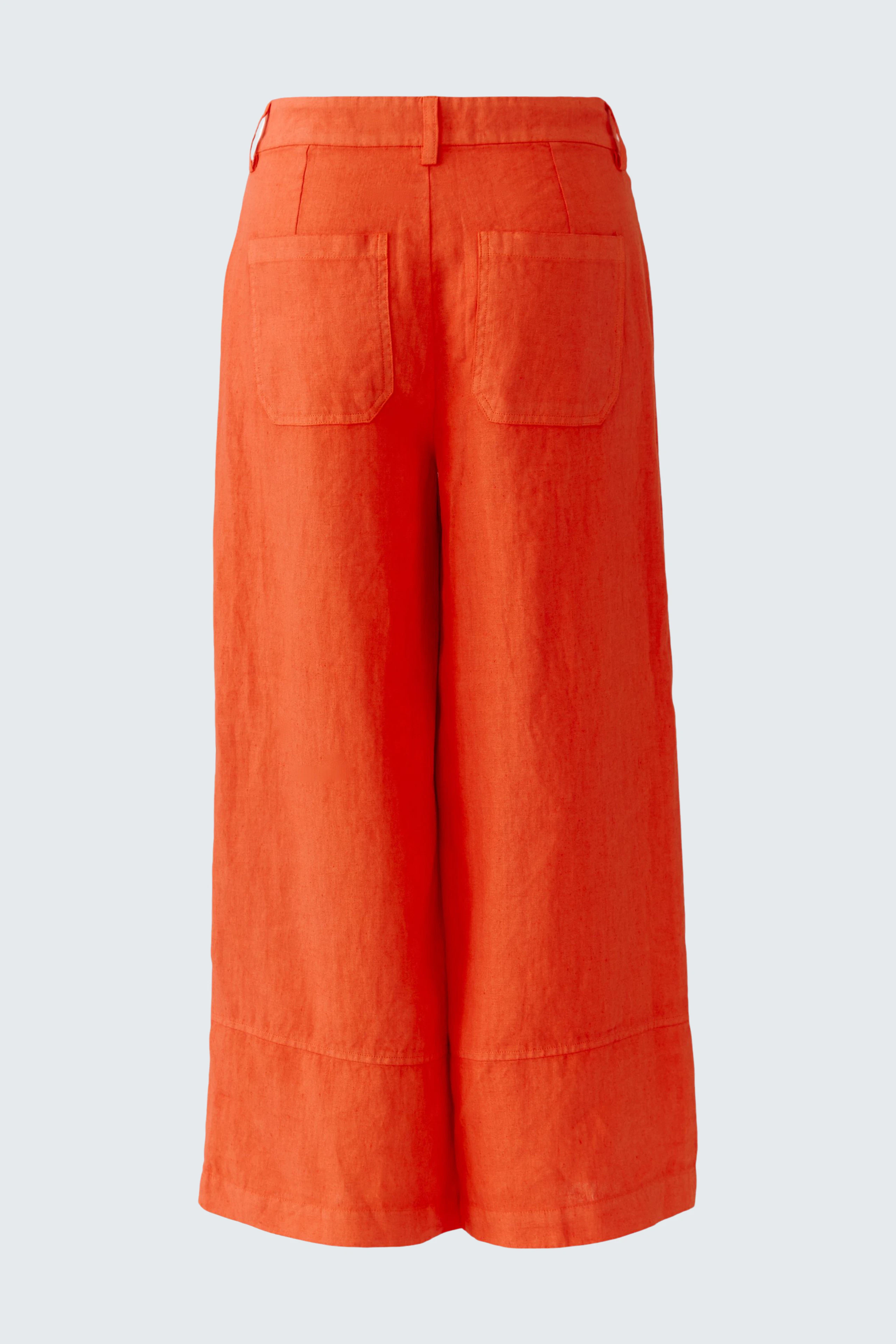Helle Damen-Hose: Weite, orangefarbene Leinenhose mit praktischen Taschen und lässigem Schnitt.
