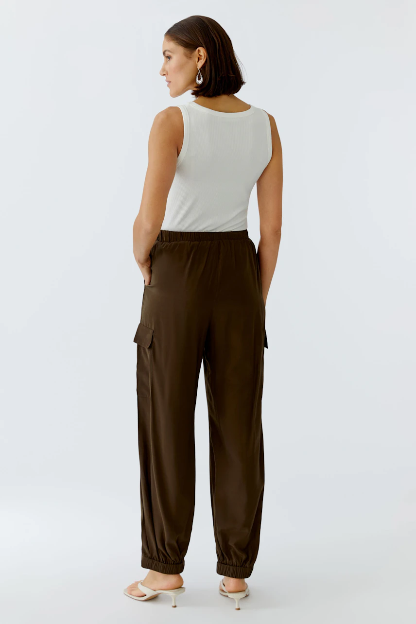 Casual women's cargo pants: A woman in brown cargo pants with a relaxed fit and elastic waistband.