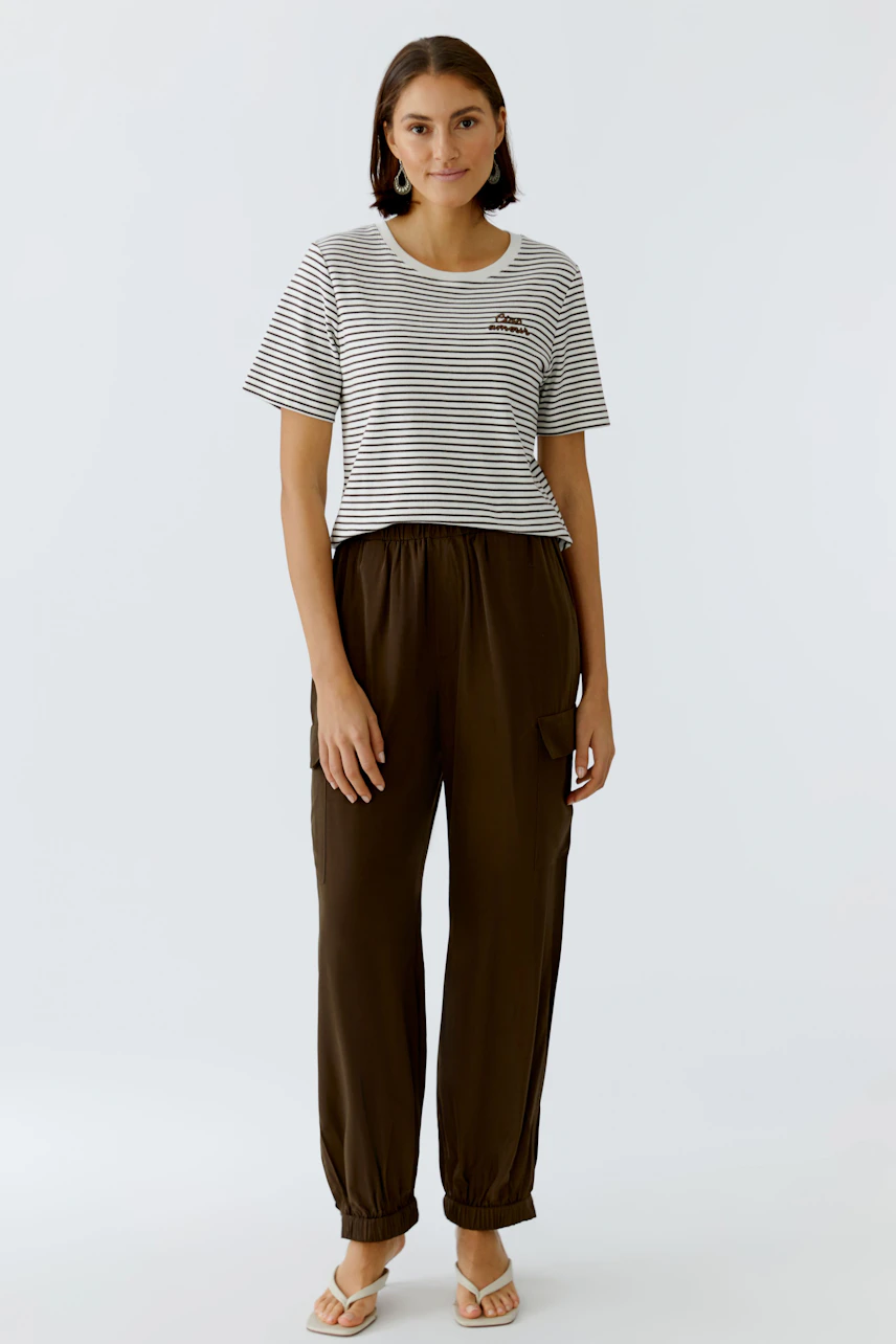Casual women's cargo pants: A woman in brown cargo pants with a relaxed fit and side pockets.