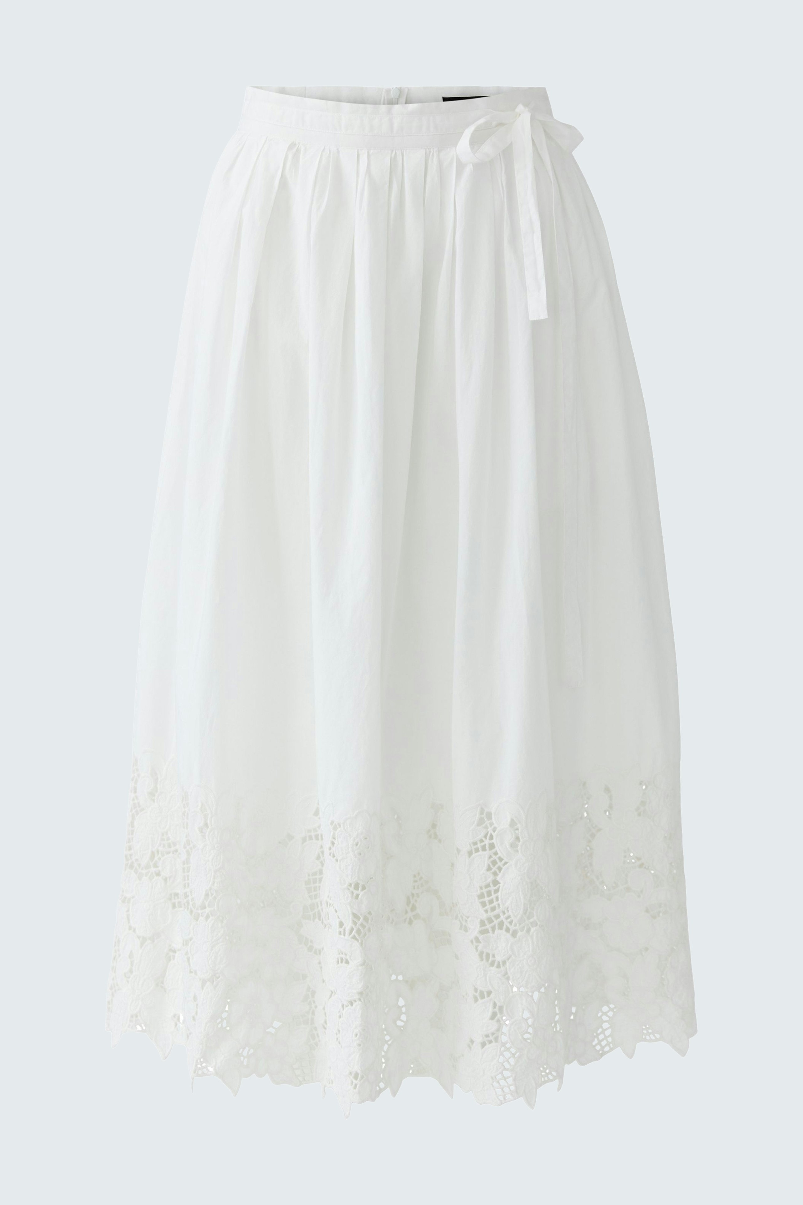 Lightweight white pleated skirt with lace detailing, perfect for casual summer outings.