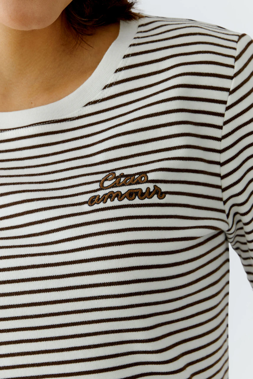 Casual women's T-shirt: Close-up of a woman in a striped top with 'Ciao amour' embroidery.