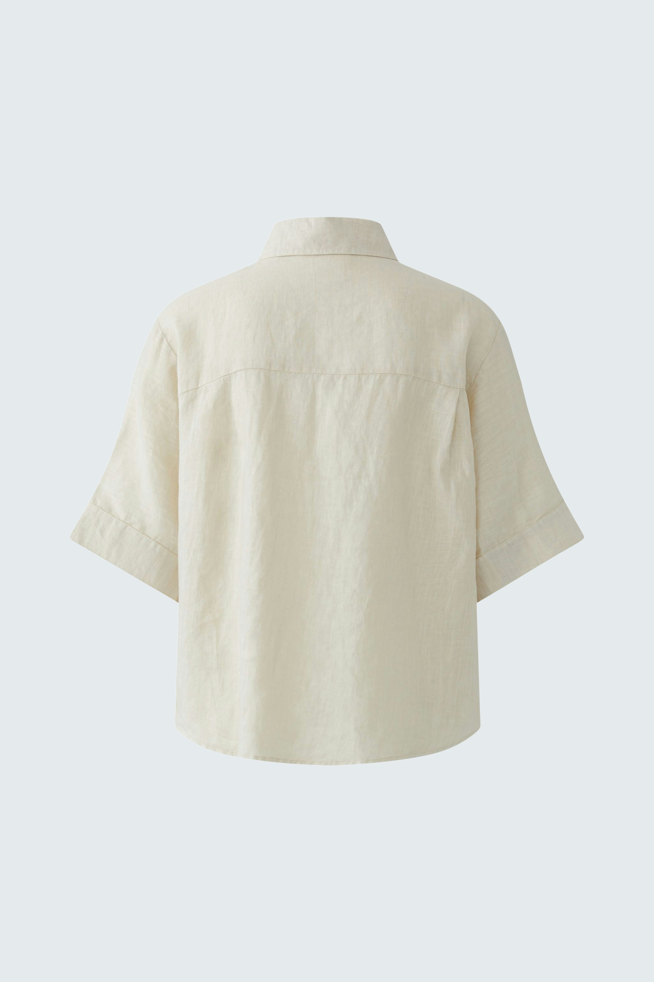 Casual women's blouse: Back view of a light-colored, short-sleeve blouse with a relaxed fit.