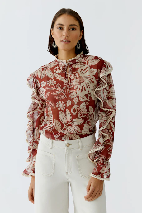Floral blouse: A stylish women's blouse with ruffled sleeves and a vibrant floral pattern.