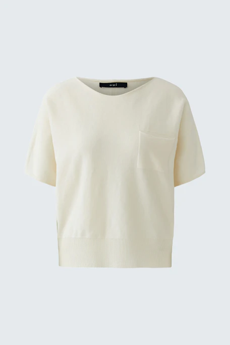 Casual women's pullover in soft cream color with short sleeves and a pocket detail.
