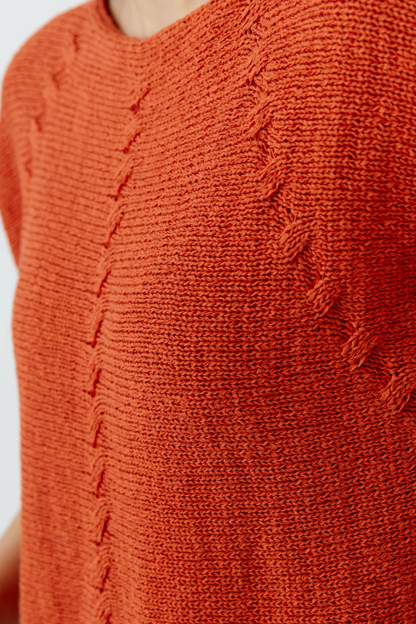 Casual women's pullover in vibrant orange with textured knit design, perfect for everyday wear.