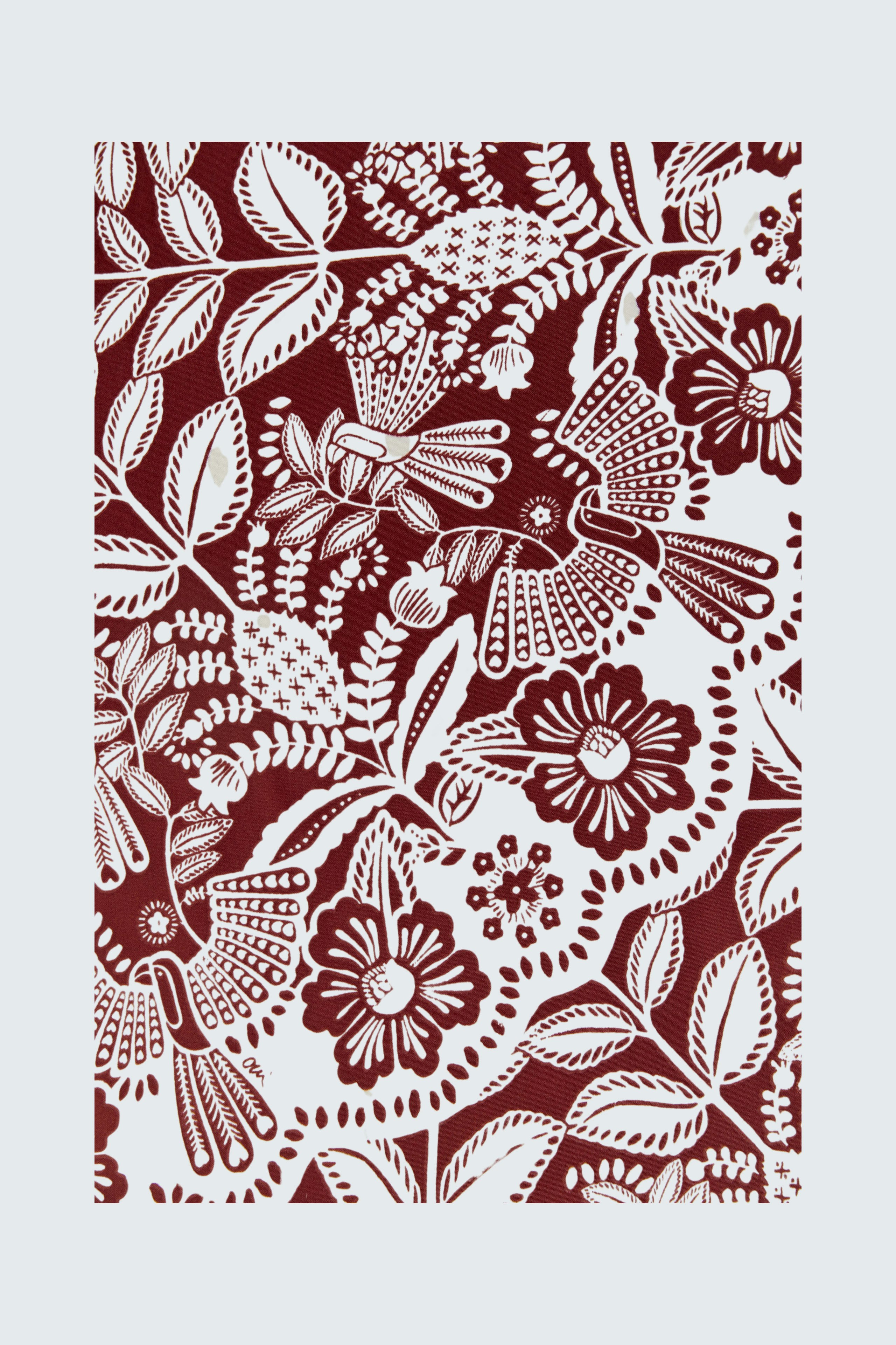 Floral patterned scarf in rich burgundy tones, perfect for adding a touch of style to any outfit.