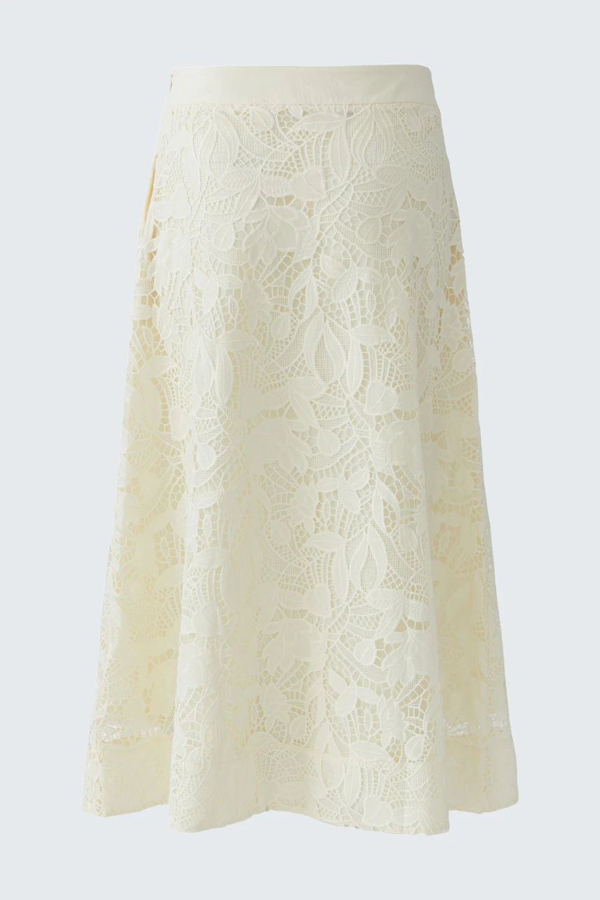 A-line skirt: A woman in a light lace skirt, showcasing a relaxed and stylish look.