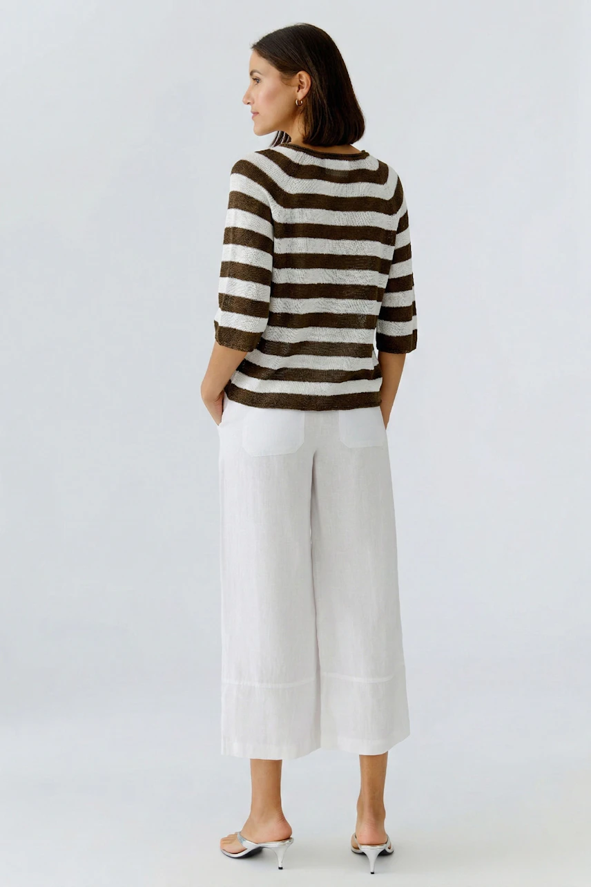 Casual women's pullover: A woman in a striped pullover with three-quarter sleeves and relaxed fit.