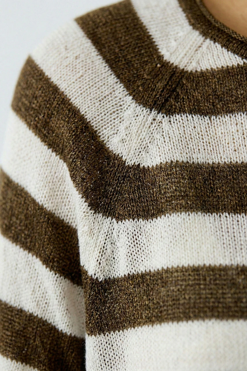 Casual women's pullover: Close-up of a woman in a striped pullover with a relaxed fit.