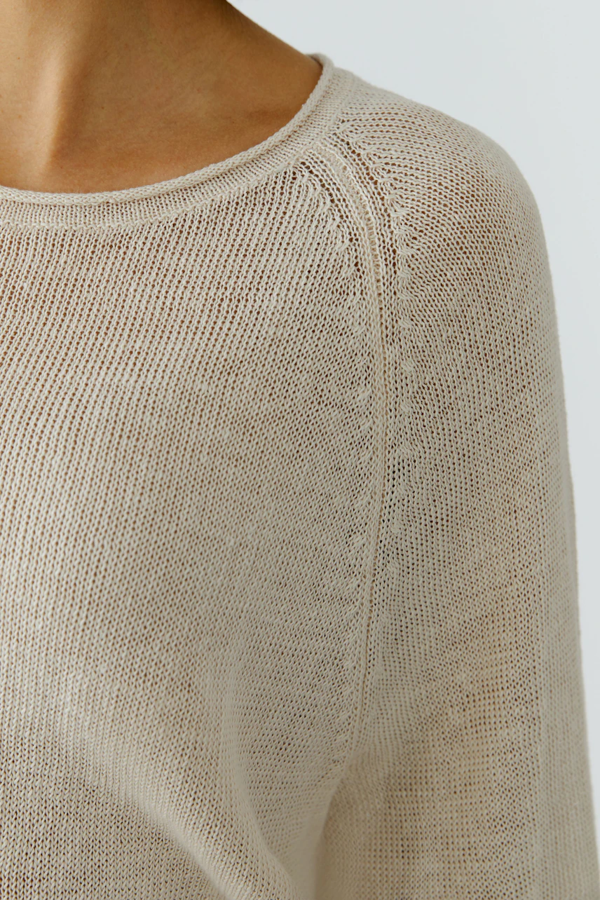 Lightweight women's pullover with a relaxed fit and open knit design, perfect for layering.