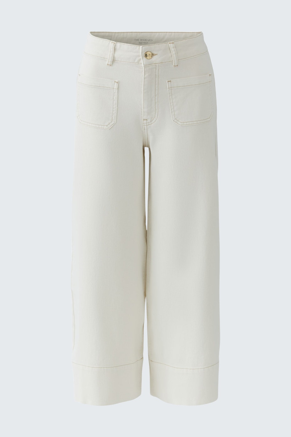 Casual wide leg jeans: A woman wearing cream-colored wide leg jeans with a relaxed fit and pockets.