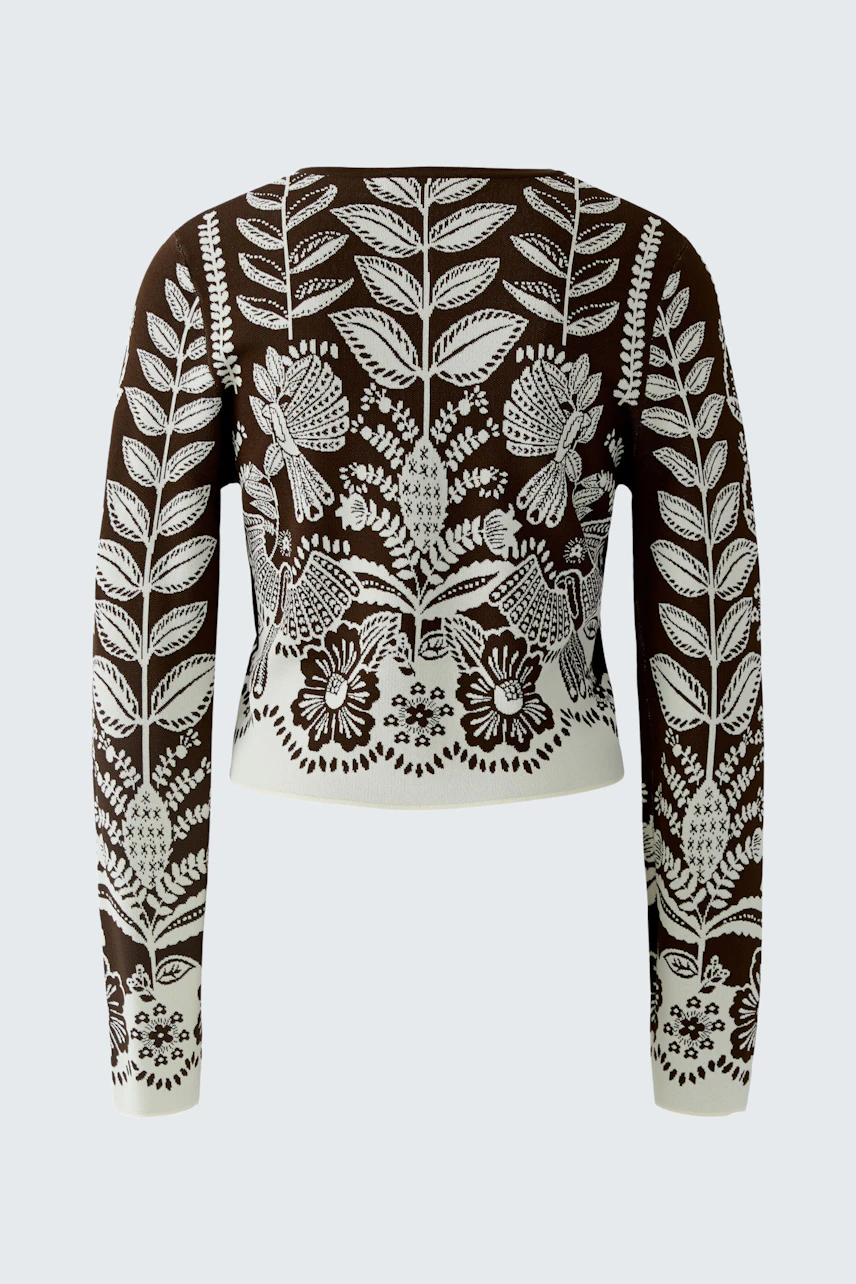 Stylish women's cardigan: A woman showcases a brown cardigan with intricate white floral embroidery.