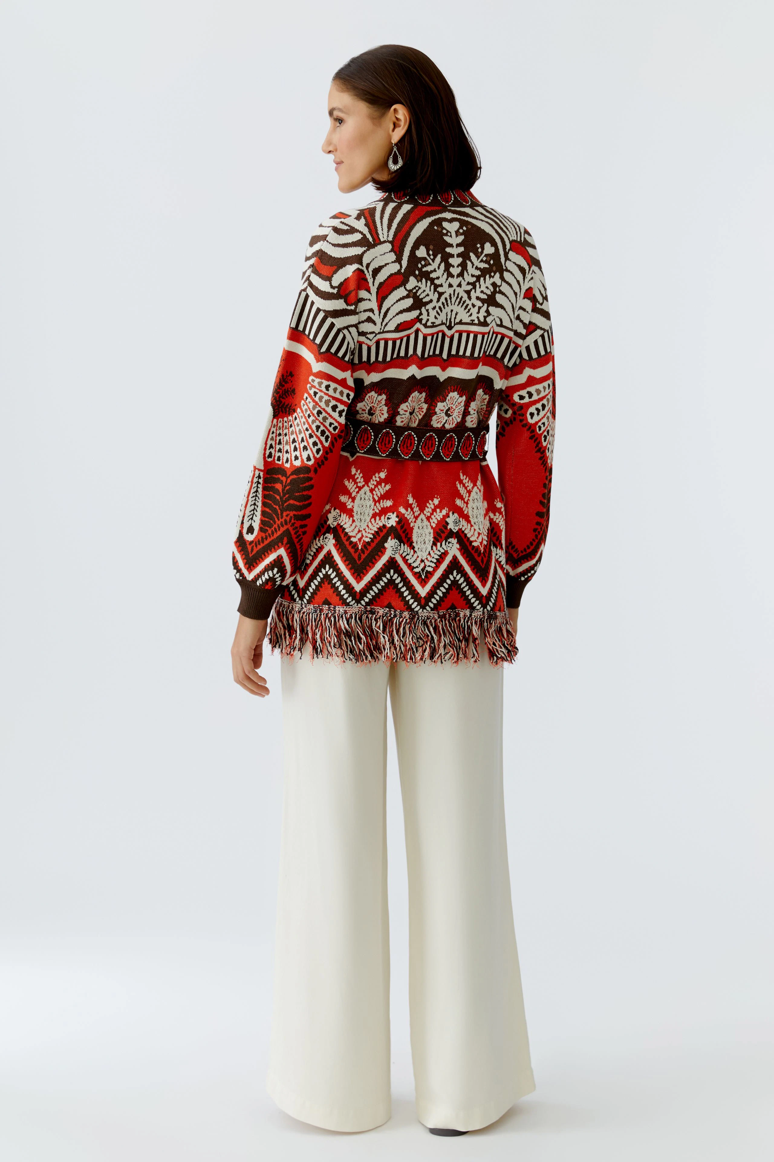 Colorful women's cardigan with fringe details, featuring a vibrant pattern and relaxed fit.