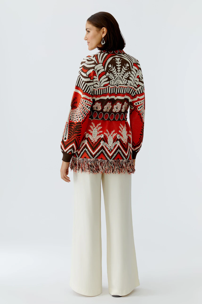 Colorful women's cardigan with fringe details, featuring a vibrant pattern and relaxed fit.