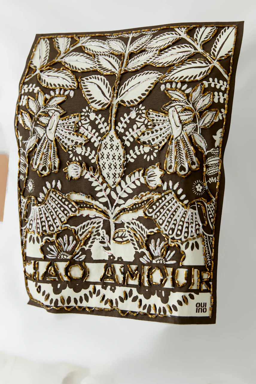 Stylish women's T-shirt featuring intricate floral embroidery and a bold 'Ciao Amour' print.