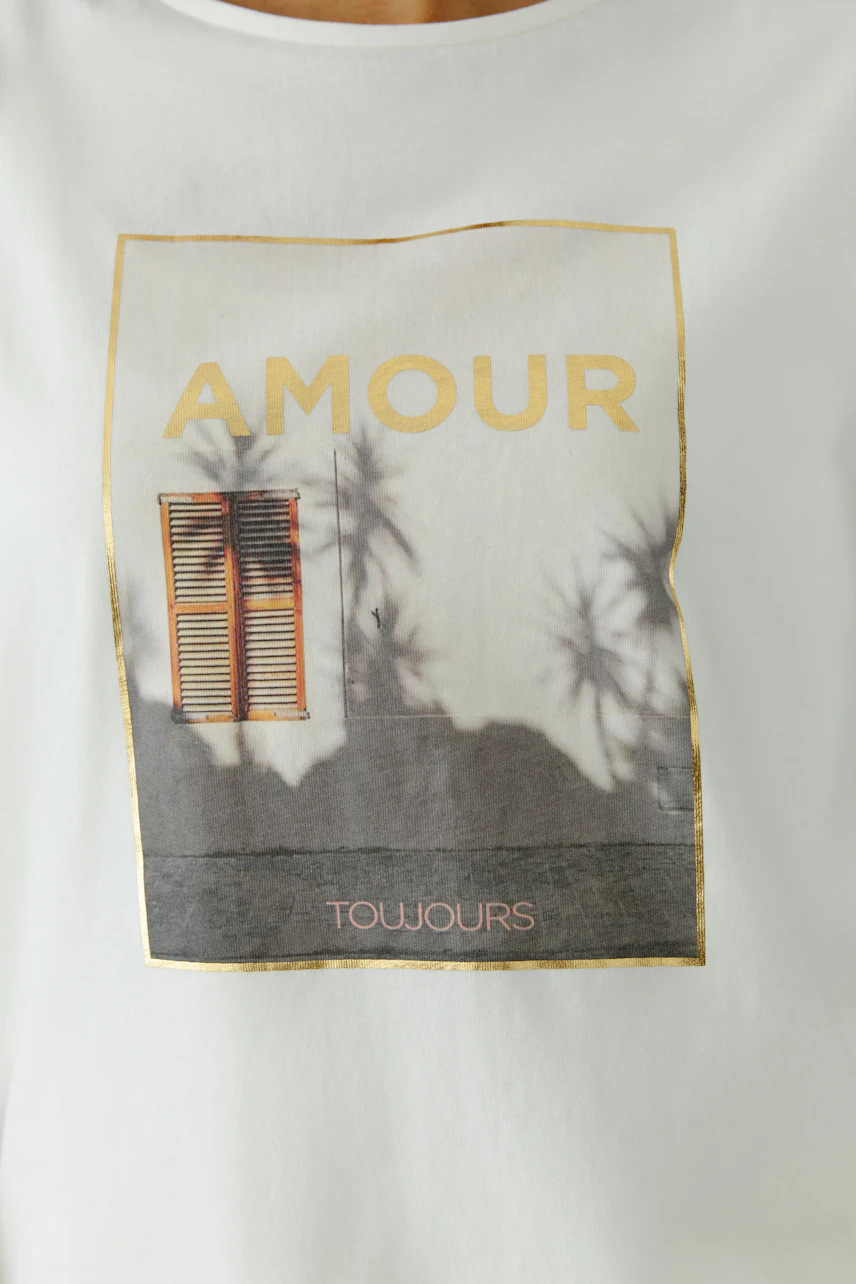 Casual women's T-shirt featuring a graphic print with the word 'AMOUR' and palm shadows.