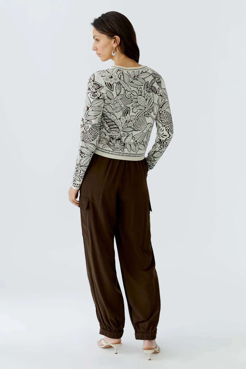 Casual women's pullover: A woman in a floral-patterned pullover paired with relaxed-fit pants.