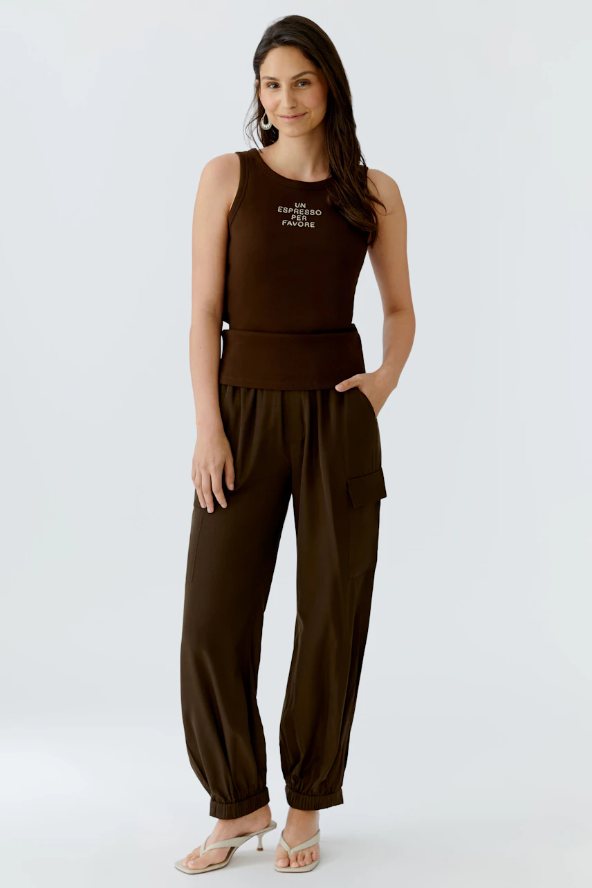 Casual women's tank top: A woman in a brown tank top with a relaxed fit, paired with matching pants.
