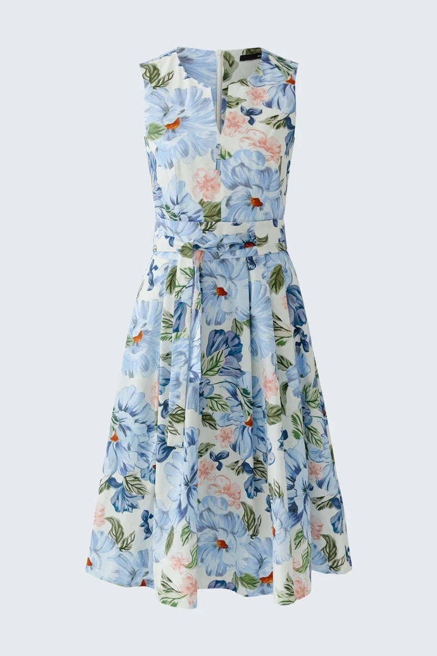 Floral midi dress: A woman in a sleeveless dress with a floral pattern and a tied waist.