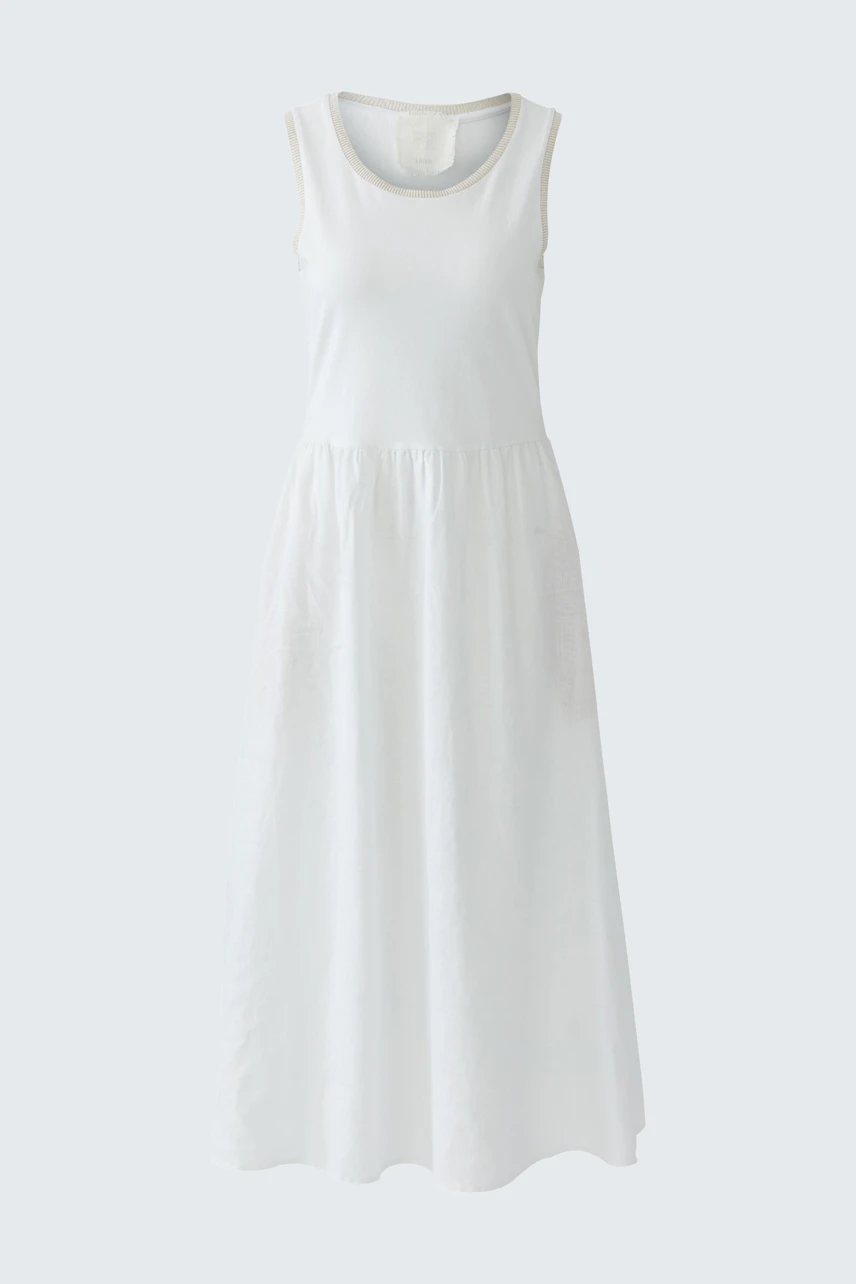 Casual white midi dress: A woman in a sleeveless, flowy dress with a relaxed fit.