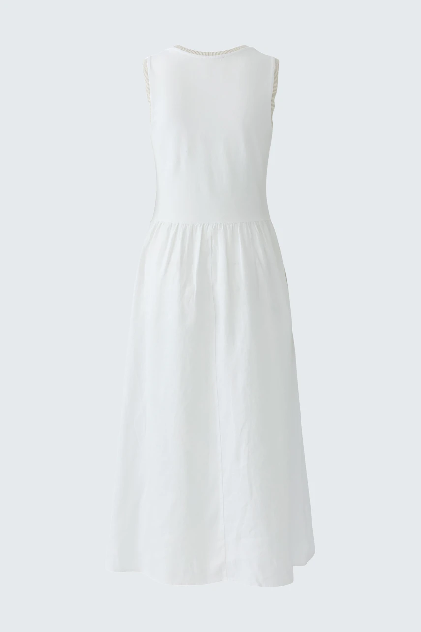 White sleeveless midi dress with a flowing skirt, perfect for casual summer days.