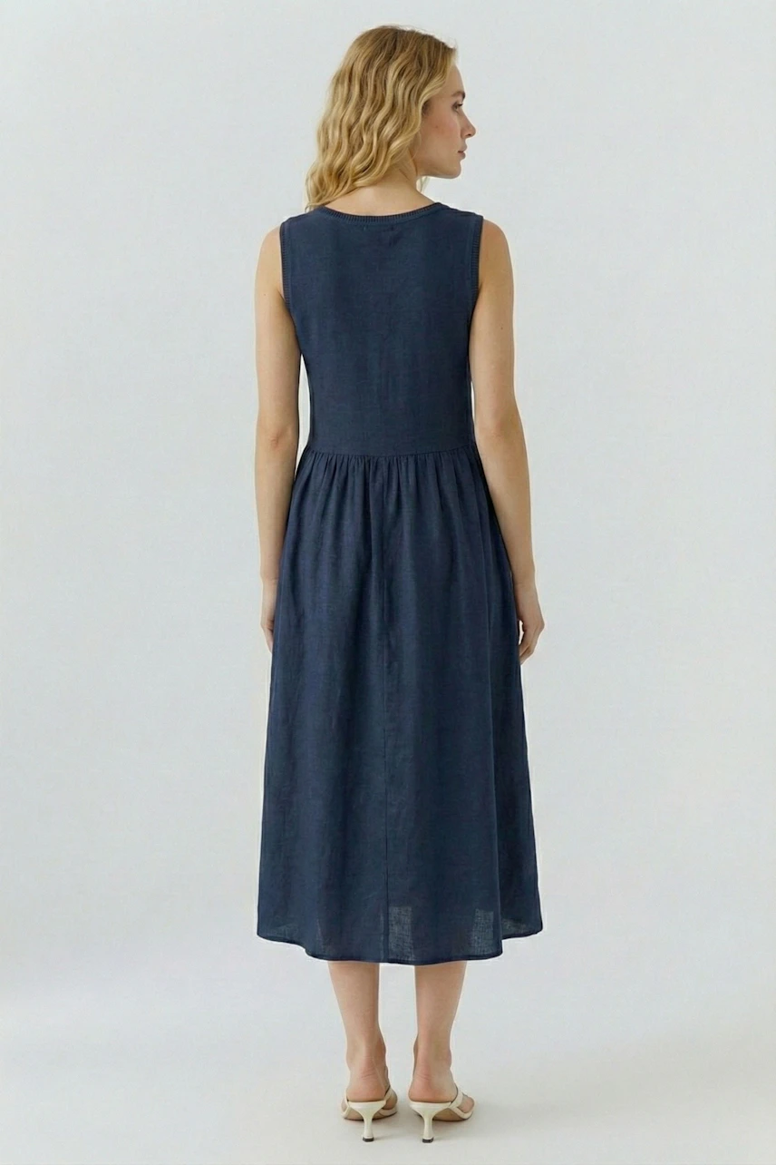 Casual midi dress: Woman in a navy blue sleeveless dress with a fitted bodice and flowing skirt.