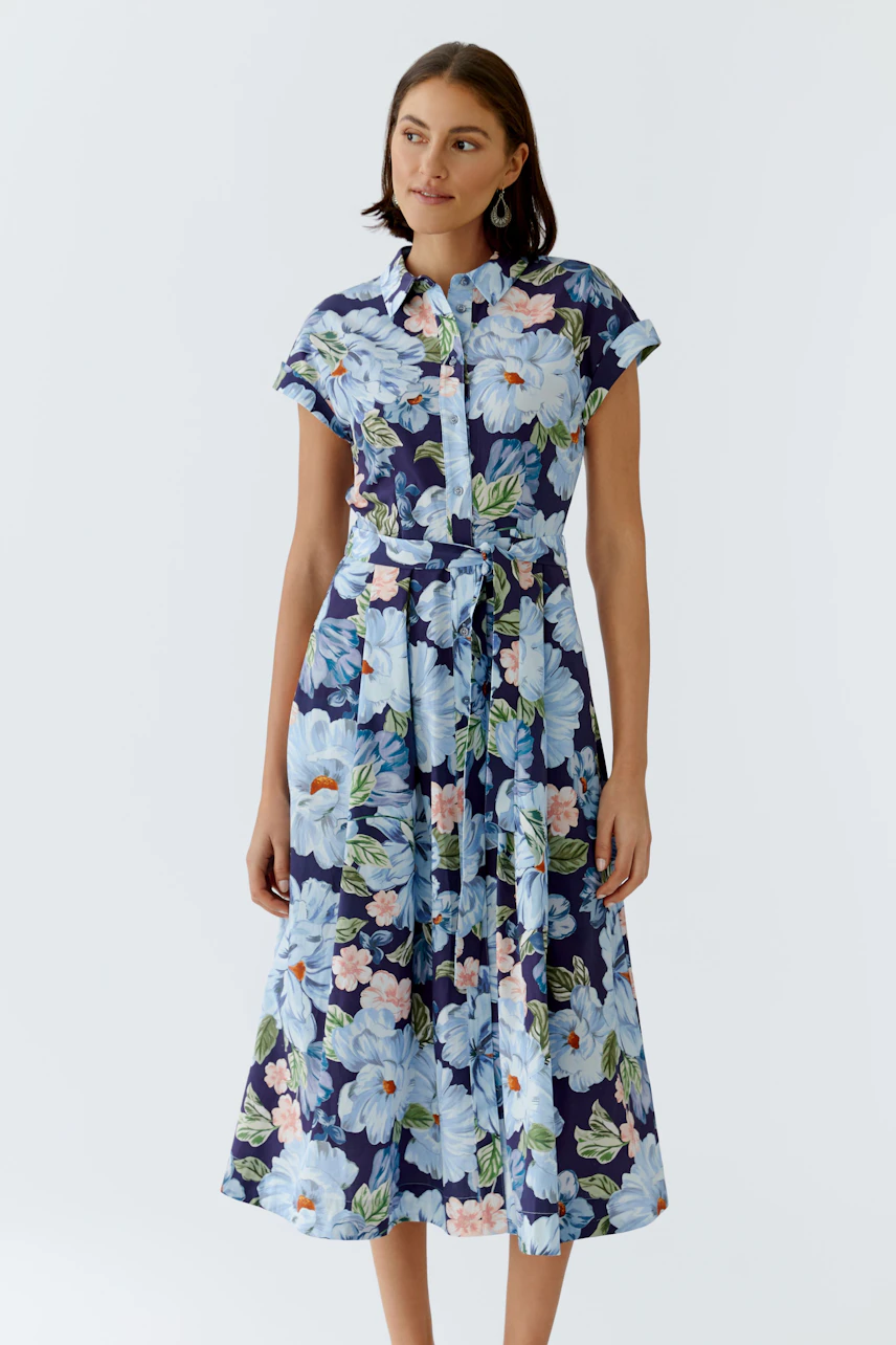 Floral midi dress: Woman in a short-sleeve dress with a tie waist and vibrant floral print.