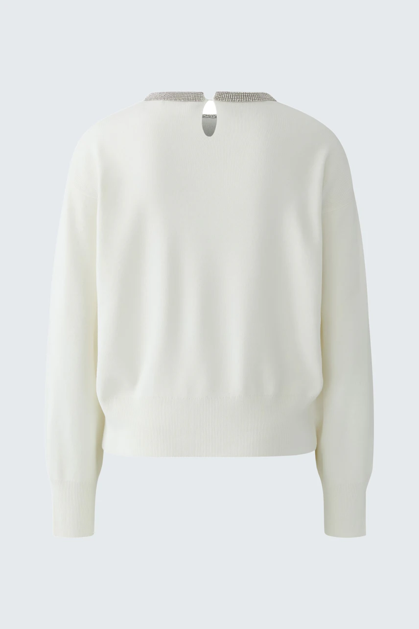 Simple white pullover with a back button detail, shown without a model.