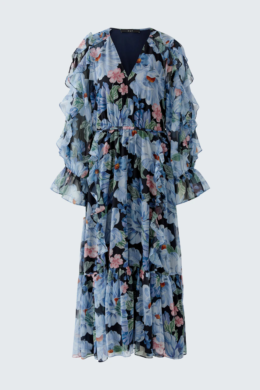 Floral maxi dress: A woman in a flowing dress with ruffled sleeves and vibrant floral patterns.