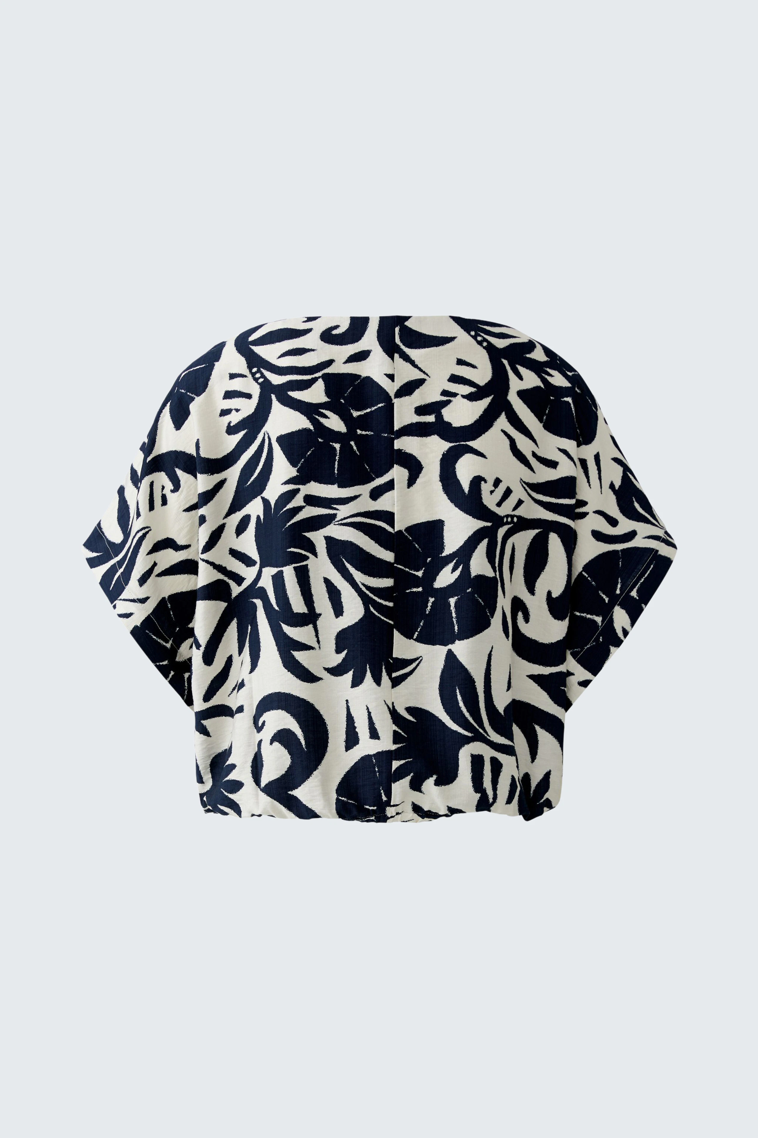 Casual blouse with bold navy and white print, short sleeves, and relaxed fit, perfect for everyday wear.