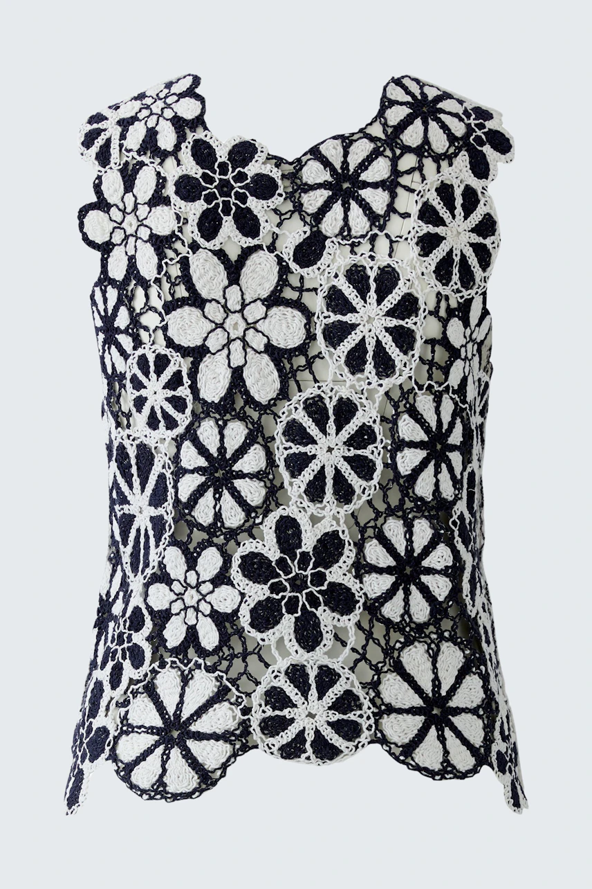 Floral crochet top: Black and white sleeveless design with bold flower patterns.