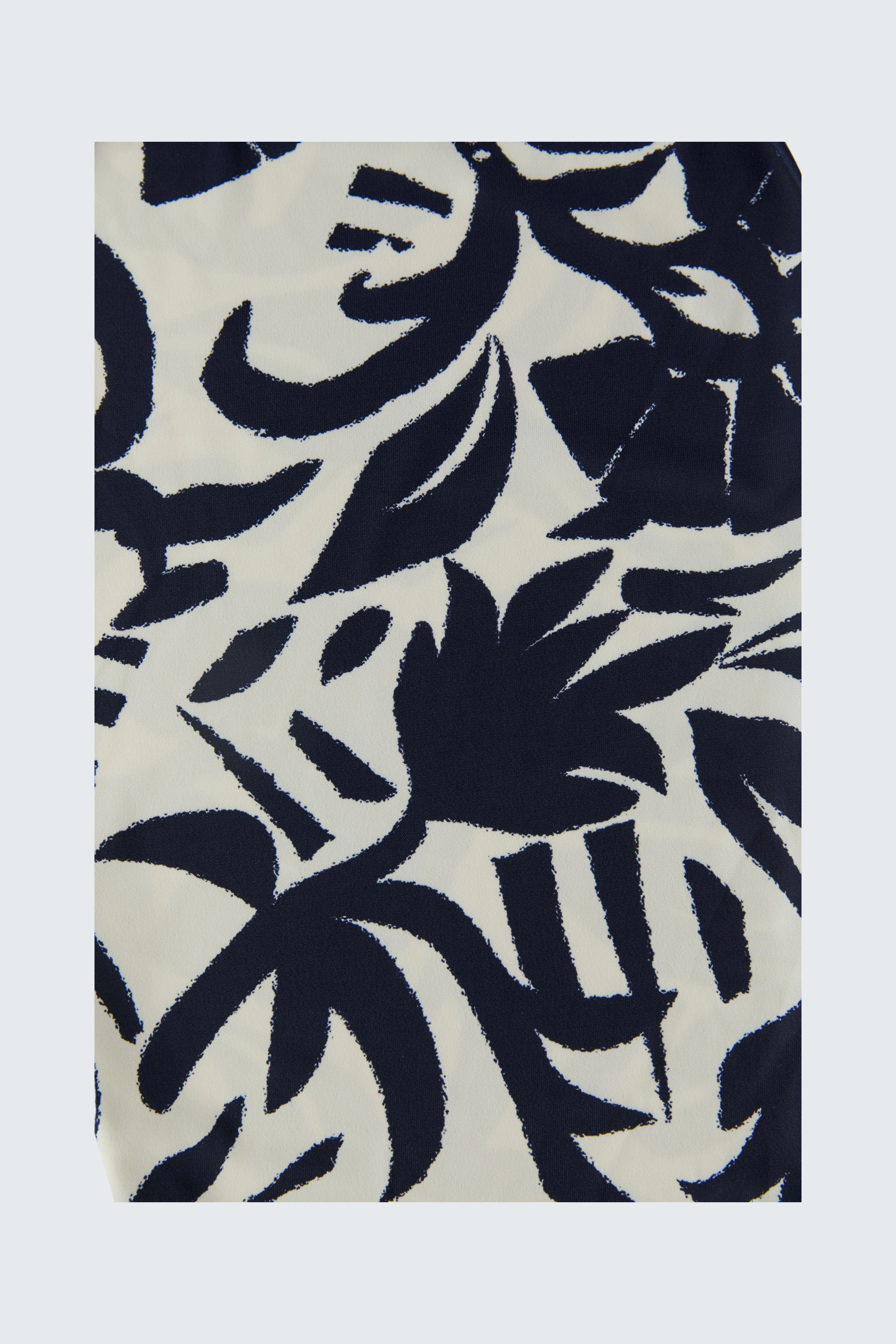 Patterned scarf: Close-up of a navy and white abstract design, showcasing bold, artistic shapes.
