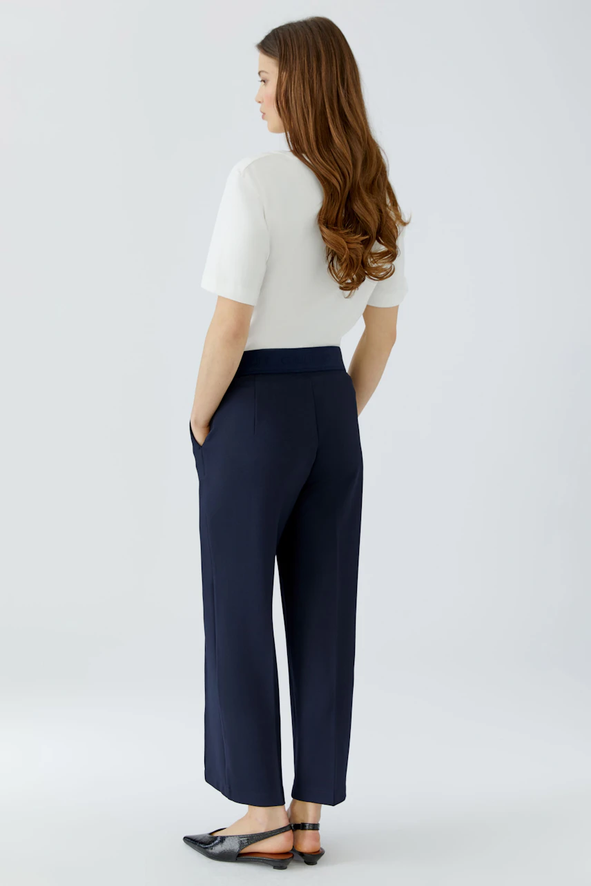 Casual women's culotte: A woman in navy culottes paired with a white shirt, showcasing a relaxed fit.