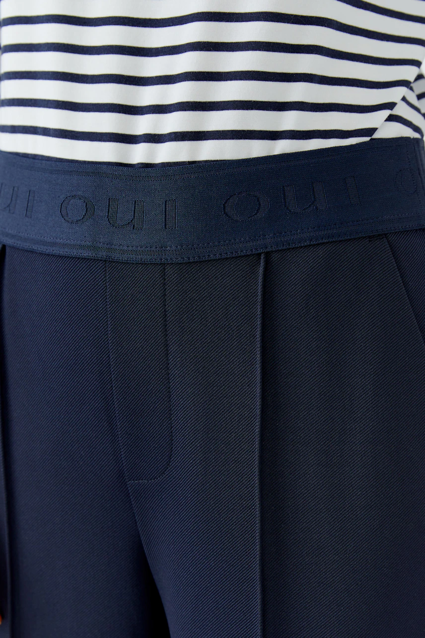 Comfortable women's trousers with a wide waistband and side pockets, perfect for casual wear.