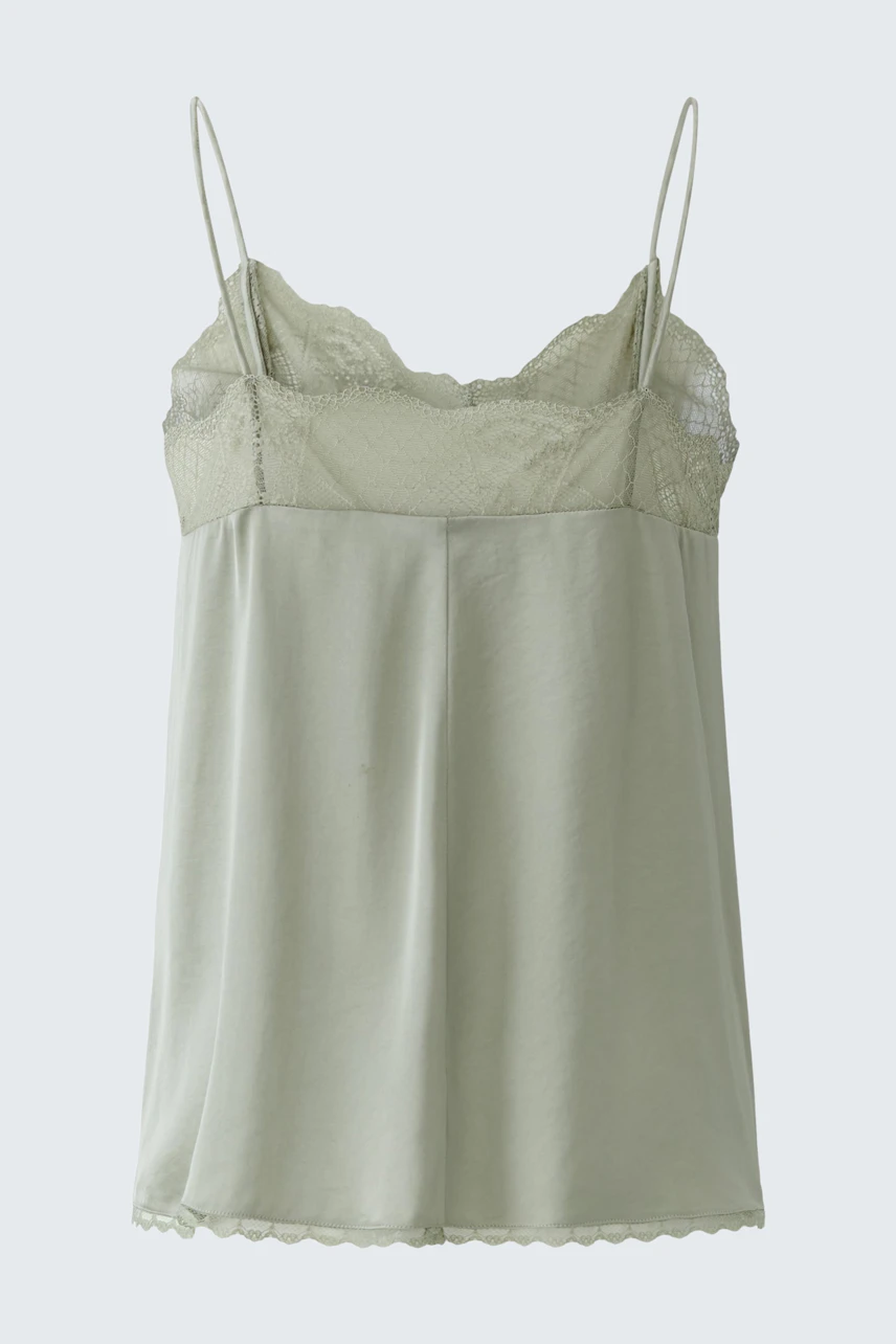 Casual women's top: Light green sleeveless top with lace details, perfect for layering.