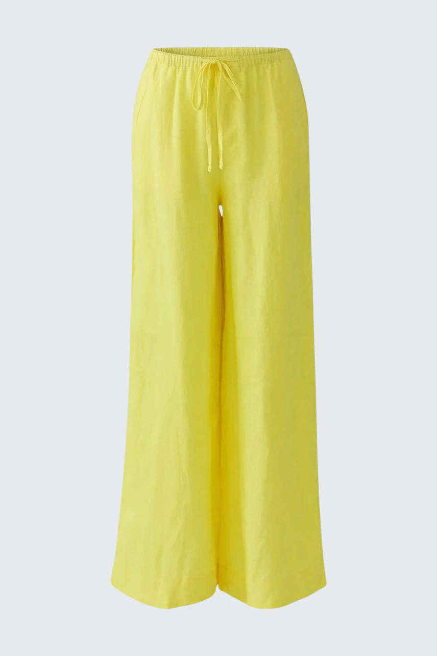 Bright yellow Marlene pants with wide legs and drawstring waist, perfect for a casual look.