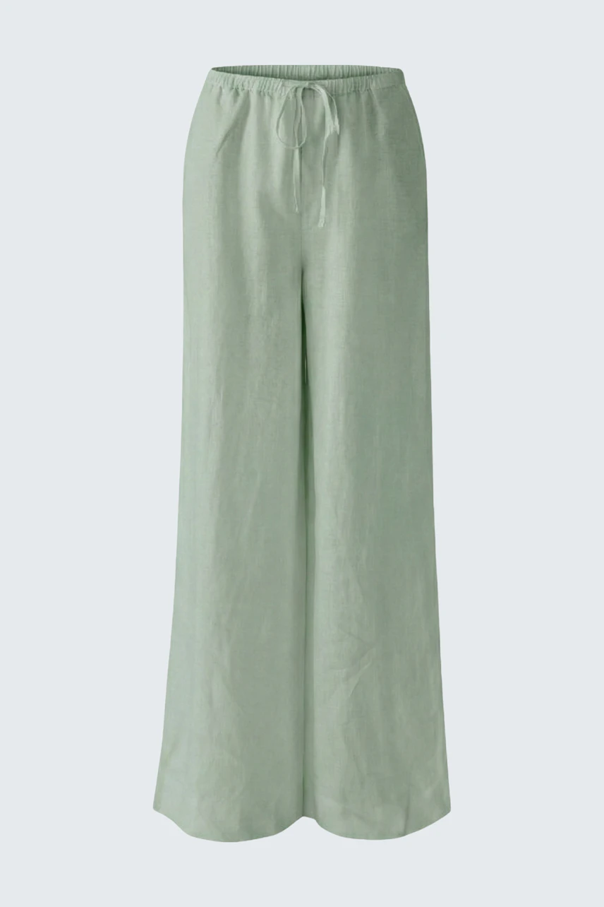 Casual Marlene trousers in light green, featuring a relaxed fit and drawstring waist, perfect for everyday wear.