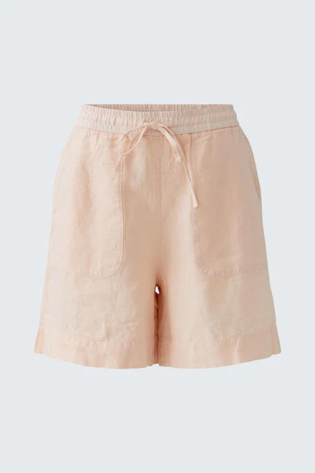 Casual women's shorts in soft peach color with an elastic waistband and side pockets.